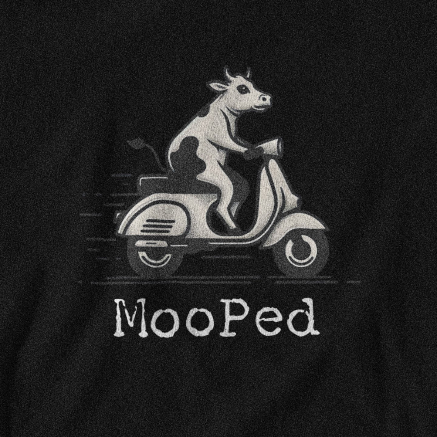 Black t-shirt with a cow riding a scooter and 'Mooped' text on a black background