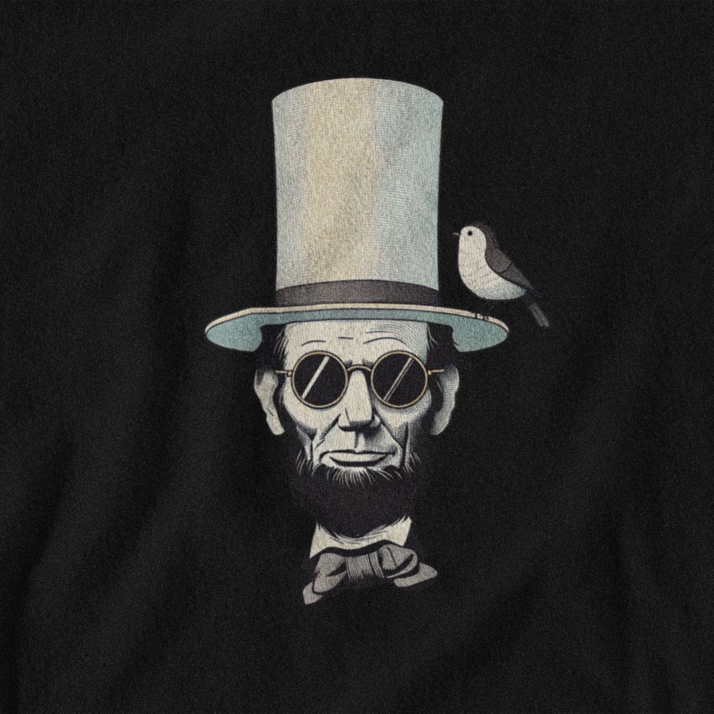 Black t-shirt with a graphic of Lincoln wearing a top hat and sunglasses, with a bird perched on his head, on a black background.