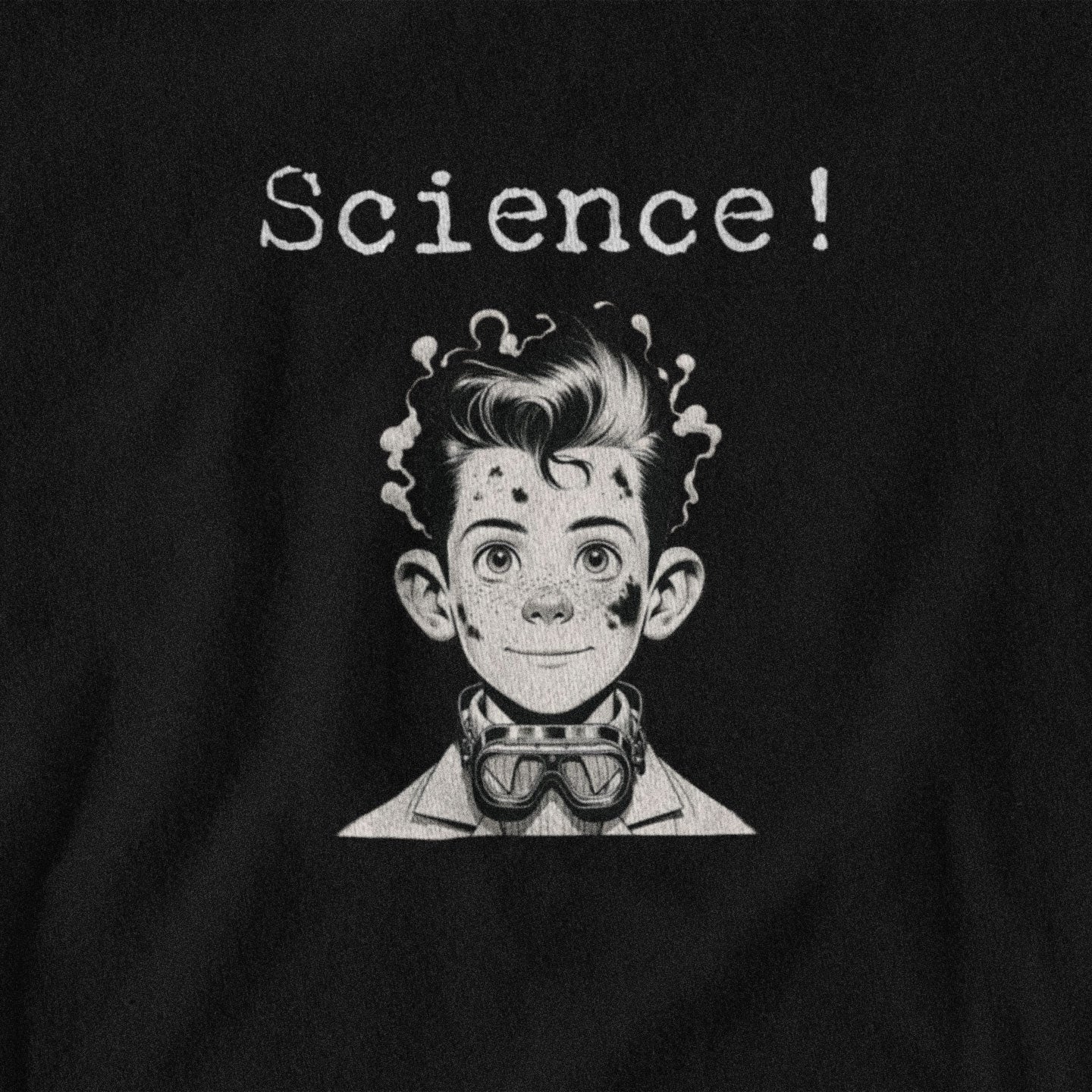 Black t-shirt with a graphic of a boy in a lab coat and goggles, text 'Science!' above, on a black background.