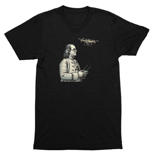 Black t-shirt with a graphic of a historical figure holding a drone on a white background