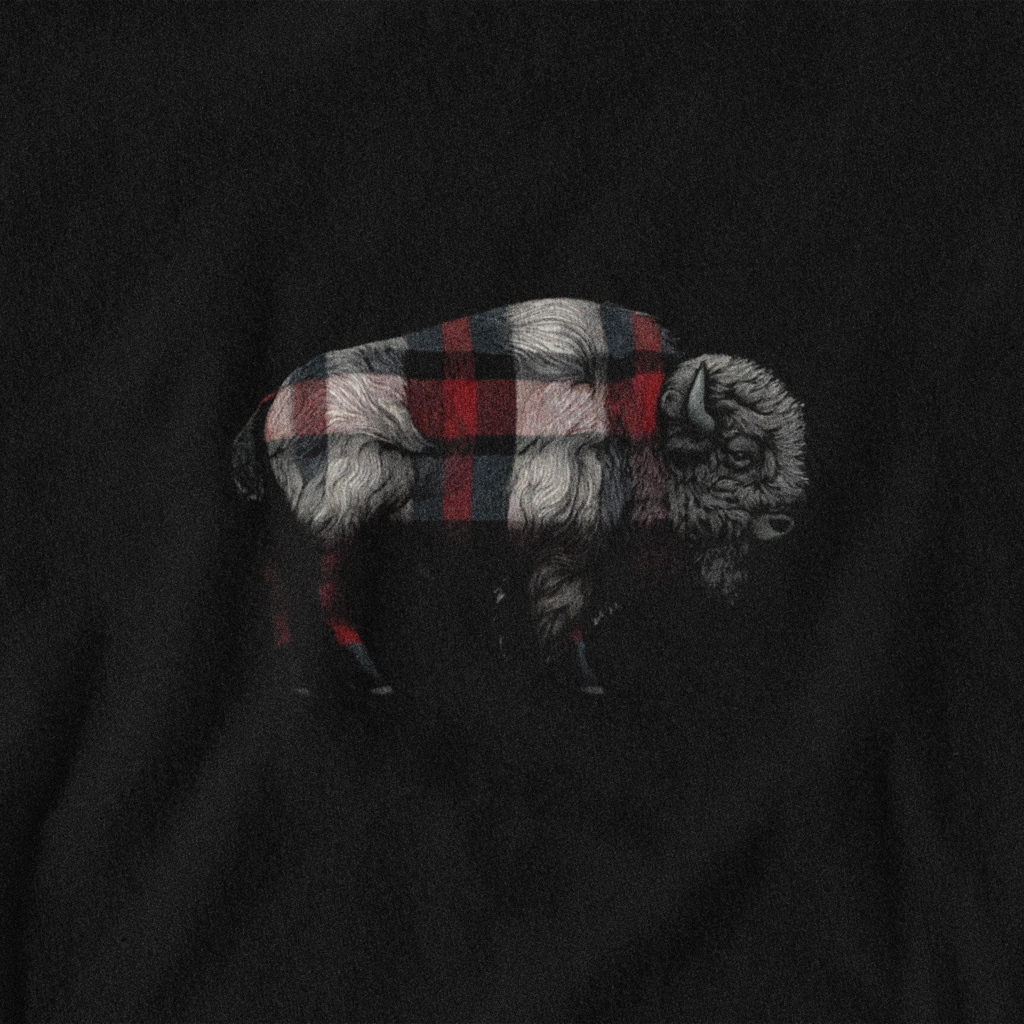 Black shirt with a plaid-patterned bison design on a dark background