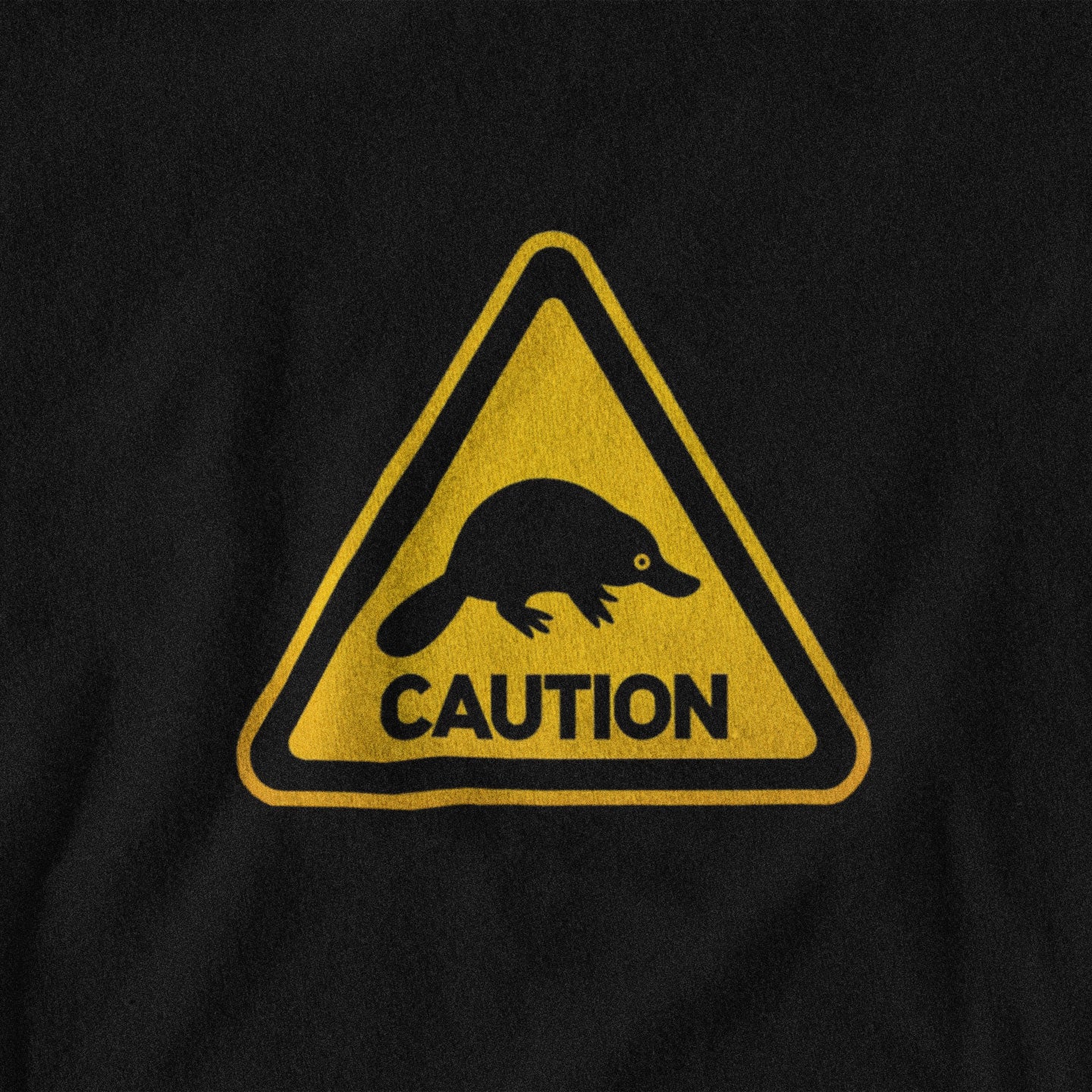 Black t-shirt with a yellow and black warning sign featuring a platypus and 'CAUTION' text.