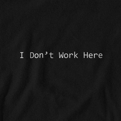 Black shirt with 'I Don't Work Here' text on a black background