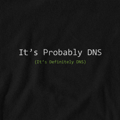 Black t-shirt with text 'It's Probably DNS (It's Definitely DNS)' on a plain background